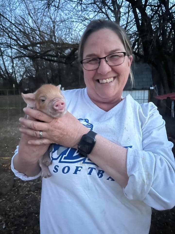 Founder, Michelle, holding piglet